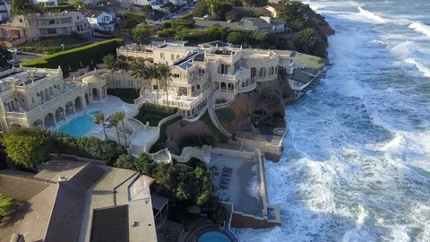 Drone aerial capture of huge waves crashing into beachfront restaurant San Diego Stock Footage 101577609
