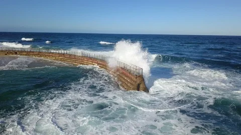 Drone aerial capture of huge waves crashing into sea wall in San Diego Stock Footage 101578809