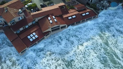 Drone aerial capture of huge waves crashing into beachfront restaurant San Diego Stock Footage 101579184