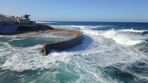 Drone aerial capture of huge waves crashing into sea wall in San Diego Stock Footage 101579372