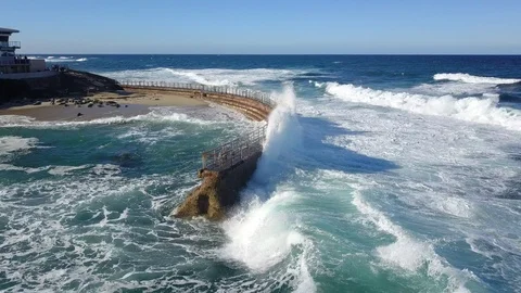 Drone aerial capture of huge waves crashing into sea wall in San Diego Stock Footage 101580254