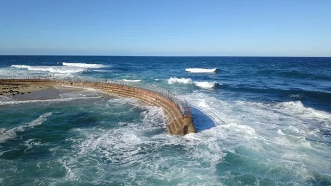 Drone aerial capture of huge waves crashing into sea wall in San Diego Stock Footage 101580510