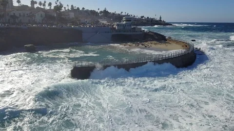 Drone aerial capture of huge waves crashing into sea wall in San Diego Stock Footage 101580769