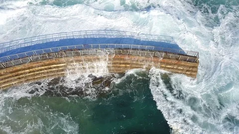 Drone aerial capture of huge waves crashing into sea wall in San Diego Stock Footage 101581458