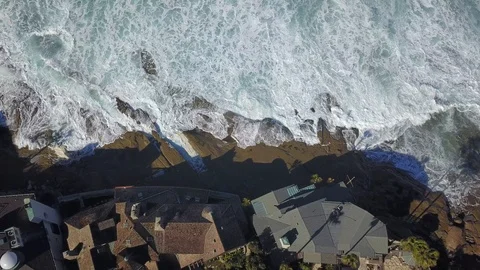 Drone aerial capture of huge waves crashing into beachfront homes San Diego Stock Footage 101581511