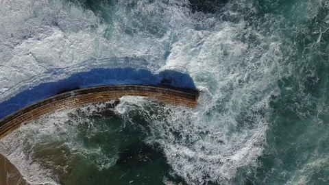 Drone aerial capture of huge waves crashing into sea wall in San Diego Stock Footage 101581612