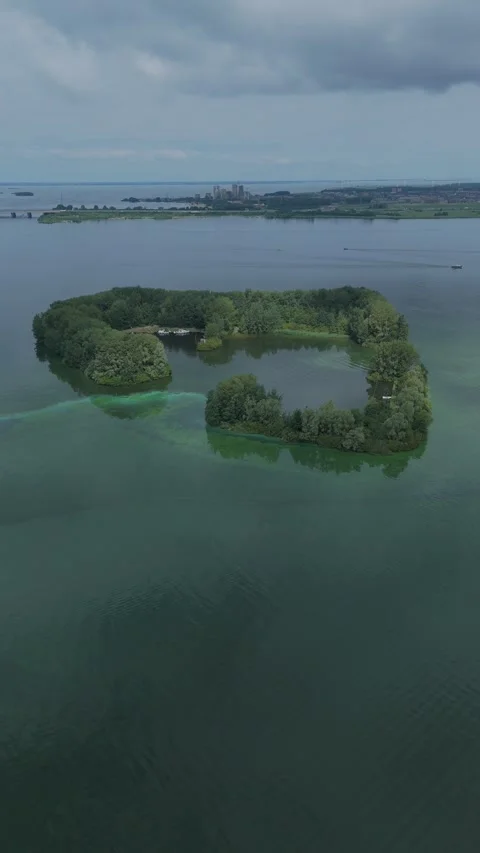 Drone aerial circling De Schelp island in Gooimeer, Netherlands Stock Footage 339683399