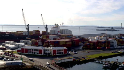 Drone aerial of container ship being unloaded by cranes Stock Footage 155366865