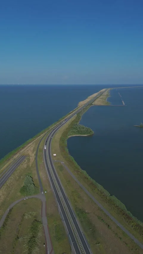 Drone aerial of dike road between Enkhuizen and Lelystad over water Stock Footage 339682122