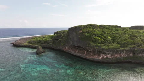 Drone aerial of dramatic limestone cliffs and lagoon waters at Lekini Bay, Ouvéa Stock Footage 315759588