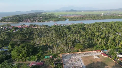 Drone aerial evening over Kuala Muda coastal village and river Stockbeeldmateriaal 333049500