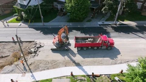 Drone aerial of excavator loading dump truck. Road construction. Toronto. 4K. Stock Footage 295312811