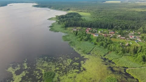 Drone aerial flight over forest, islands, swamp and village. Skies reflection Stock Footage 170128768