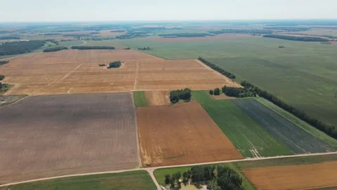 Drone aerial flight over the multicolored square agricultural fields Stock Footage 170073019