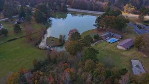 Drone aerial fly view to small two lakes fall pretty colors riverdale ga Stock Footage 170461665