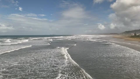 Drone aerial forward flight video over beach and ocean waves in Santa Catarina Stock Footage 316360134
