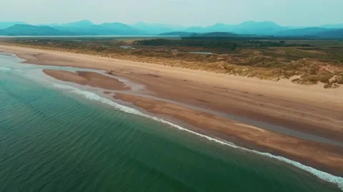 Drone Aerial Of Harlech Beach With Views Of Snowdonia Mountains, North Wales Stock Footage 153796471