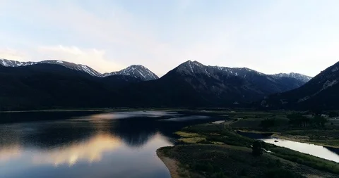 Drone aerial of high alpine mountain lake at sunset Video stock 123083373