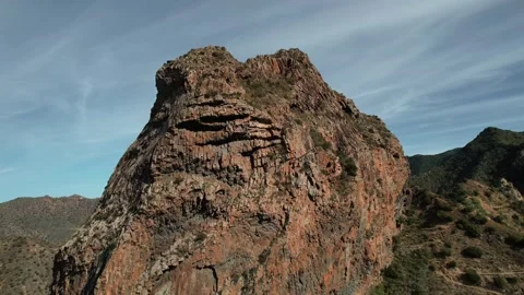 Drone aerial of isolated volcanic plug in dry terrain Stock Footage 331082029