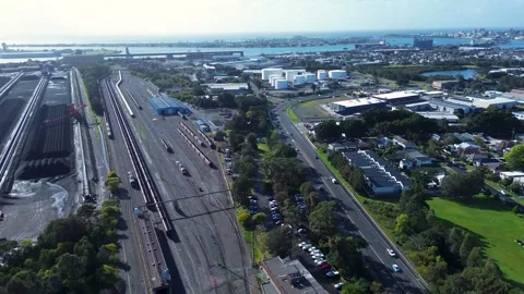 Drone aerial landscape of coal train yard and cars driving along main road Stock Footage 345966488