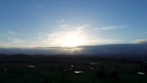Drone aerial landscape of sun rays breaking through clouds in the afternoon sky Stock Footage 341332715