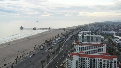 Drone aerial of large beach resort hotels along ocean highway with pier Video stock 98854553