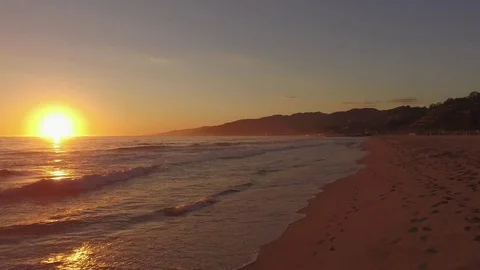 Drone aerial low fly over santa monica beach waves sunset Stock Footage 83995750