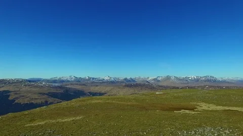 Drone Aerial of Men Walking Summit Plateau in Mountains Video stock 81719419