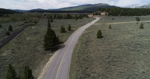 Drone aerial of motorcycle on empty alpine road Video stock 99025151
