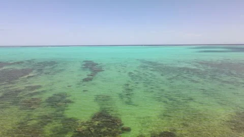 Drone aerial moving backwards over a beautiful ocean in New Caledonia Stock Footage 319059026