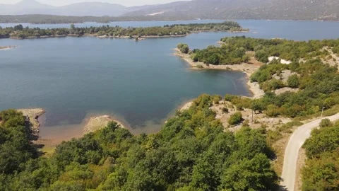 Drone aerial moving forward pan down over Krupac Lake on sunny day Stock-Footage 347486331
