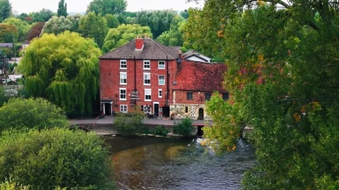 Drone aerial of Old Mill Hotel by river in Bath England Stock Footage 331564683