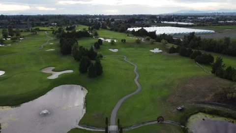 Drone aerial over golf course with Canadian shaped maple leaf and heart bunker Stock Footage 344190259