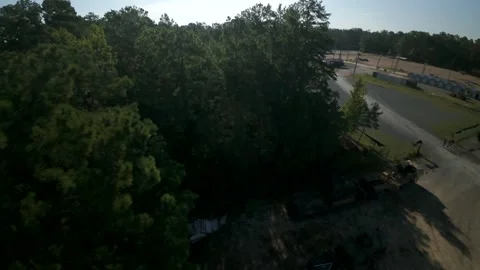 Drone aerial over pine forest edge beside rural facility Stock Footage 346635730