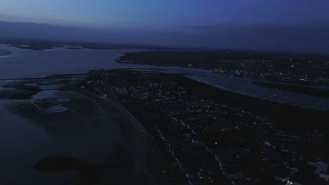 Drone aerial over Point Clear, Essex. Nighttime / evening coastal landscape. Stock Footage