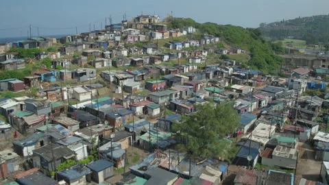 Drone aerial over shacks to a view of the sea Video stock 239369218