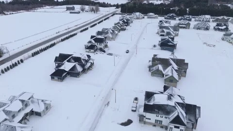 Drone aerial over snow-covered new housing subdivision in Caledon, Ontario Stock Footage 325832870