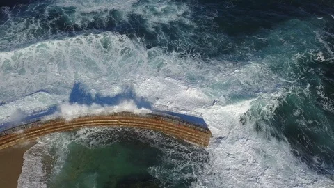 Drone aerial overhead view of huge waves crashing into sea wall in San Diego Stock Footage 101581015