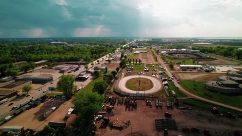 Drone Aerial Overview of Rural Oval Raceway and Event Facilities Under Dramatic Stock Footage 310304680