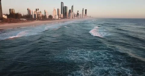 Premium stock video - Looking back at surfers paradise from water with drone