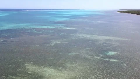 Drone aerial panning left over a blue ocean landscape in New Caledonia Stock Footage 319058900