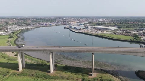 Drone Aerial Pull Out of Highway Traffic Crossing Large Concrete Bridge Over Stock Footage 337141343