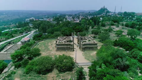 Drone Aerial Pullback of Ancient Gopura Ruins and Lush Landscape in Melukote Stock Footage 334831719