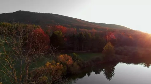 Drone Aerial Rise Over Sunset Lake And Mountains Stock Footage