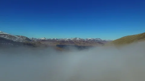 Drone Aerial Rising through Clouds to Reveal Mountains Video stock 81719285
