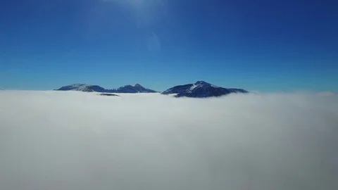 Drone Aerial Rising through Clouds to Reveal Mountains Video stock 81719302