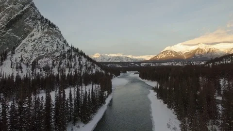 Drone aerial river fly over banff snow sunset Stock Footage 83993334