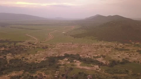 Drone aerial rotating around a sunset view of the Serengeti plains in Tanzania Vídeos de archivo 249348647