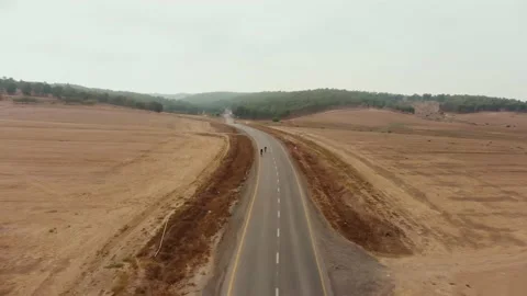 Drone aerial shot of the desert's empty road showing the endless horizon Stock Footage 165377266
