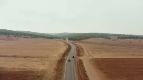 Drone aerial shot of the desert's empty road showing the endless horizon Stock Footage 165377307
